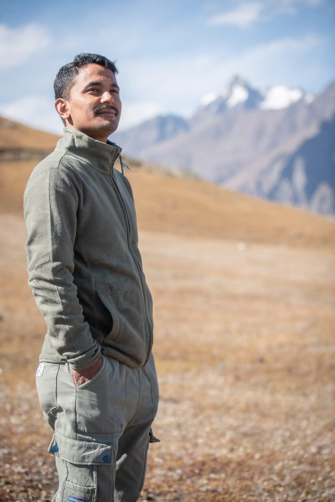 Your Spiti Valley taxi driver standing against the dramatic Himalayan landscape